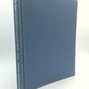May include: A hardcover book with a blue cover. The title "How To Make $100,000 Farming 25 Acres" is printed vertically on the spine. The author's name, Whaley, and the Regenerative Agriculture Association are also listed.