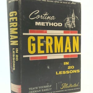 May include: A vintage book titled "Cortina Method German in 20 Lessons." The cover is black with yellow and white text. The book features an illustration of a castle and the text "Teach Yourself German Easily!"