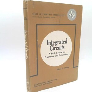 May include: A vintage textbook titled "Integrated Circuits" by Robert G. Hibbard. The cover is a light brown with a white circle containing the title. The book is part of the Texas Instruments Electronics Series.