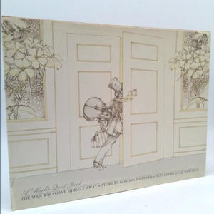 May include: A vintage book cover with a black and white illustration of a person carrying a suitcase and a drum, walking through a doorway. The text on the cover reads "A Marlin Baird Beck, The Man Who Gave Himself Away, Story by Gordon Sheppard, Pictures by Jacques Rozler."