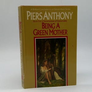 May include: A hardcover book titled "Being a Green Mother" by Piers Anthony. The cover is gold with red and white text. The book's cover art depicts a woman with a harp in a forest setting.