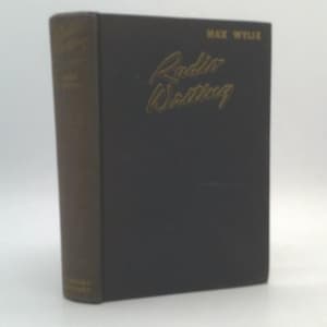 May include: A hardcover book titled "Radio Writing" by Max Wylie. The book has a dark cover with gold lettering and a brown spine. The book is standing upright against a white background.