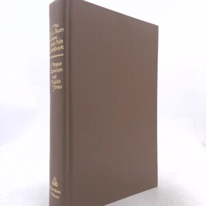May include: A brown hardcover book titled The L.L. Bean Game and Fish Cookbook by Angus Cameron and Judith Jones. The spine features gold lettering and a small logo at the bottom, with the publisher Random House printed below the logo.