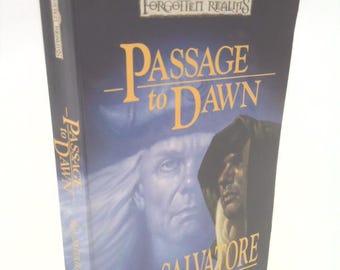 May include: A blue and white book cover with the title "Passage to Dawn" and the author's name "R.A. Salvatore". The book is a New York Times Bestseller and part of the Forgotten Realms series.