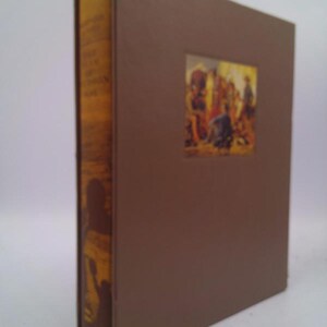 May include: A brown hardback book with a gold spine. The spine has the title "The Adventures of Tom Sawyer" printed on it. The front cover has a small image of a group of people in a scene from the book.