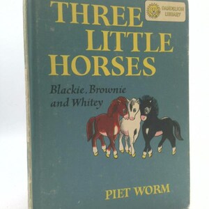 May include: Vintage children's book titled "Three Little Horses" with a teal cover. The title is in large yellow letters, with the names Blackie, Brownie, and Whitey below. The cover features illustrations of three horses. The author's name, Piet Worm, is at the bottom.