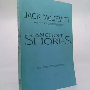 May include: A teal blue book cover with the title "Ancient Shores" by Jack McDevitt, author of "Engines of God". The book cover also says "Uncorrected Page Proofs".