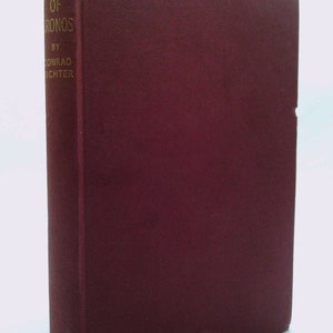 May include: A burgundy hardcover book with gold lettering on the spine. The title is "The Waters of Kronos" by Conrad Richter.