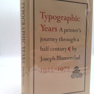 May include: A tan book with the title "Typographic Years" and the subtitle "A printer's journey through a half century by Joseph Blumenthal 1925-1975".