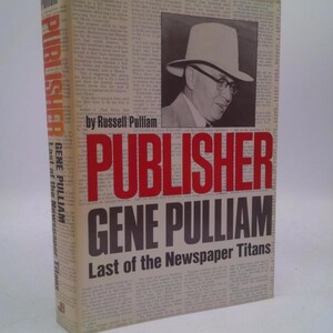 May include: A hardcover book titled "Publisher Gene Pulliam: Last of the Newspaper Titans" by Russell Pulliam. The cover features a portrait of a man in a hat and glasses, with the title in large red and black letters.