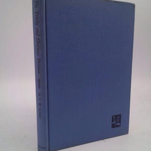 May include: A blue hardcover book titled "The Trinity and Christian Devotion" by C.W. Lotry. The book has a small, black and white logo on the bottom right corner.