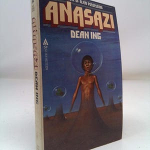 May include: A vintage paperback book titled "Anasazi" by Dean Ing. The cover features a blue background with a figure in a bubble, and the title in large, bold letters. The book is a novel of alien possession.