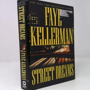 May include: A hardcover book titled "Street Dreams" by Faye Kellerman. The cover is black with yellow lettering and a nighttime cityscape image. The book is published by Warner Books.