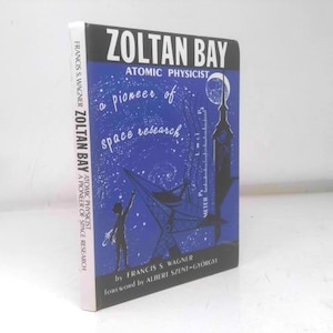 May include: A hardcover book titled "Zoltan Bay, Atomic Physicist, a Pioneer of Space Research" by Francis S. Wagner. The cover is blue with white text and illustrations of space-related imagery.