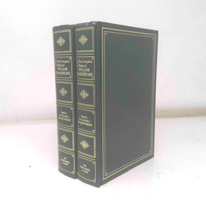 May include: Two dark green hardcover books titled "The Complete Works of William Shakespeare" with gold lettering and accents. The books are from the Wordsworth Classics collection.