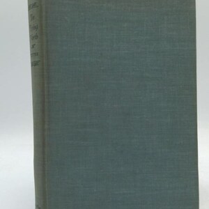 May include: A vintage book with a teal cover. The spine displays the title "The Flying Earth or Some Other Worlds". The book has a textured appearance and is set against a white background.
