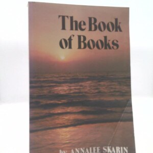 May include: The Book of Books by Annalee Skarin, a book cover with a sunset over the ocean.