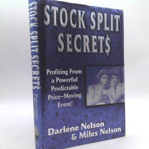 May include: A hardcover book titled "STOCK SPLIT SECRETS" with a blue cover and silver lettering. The book's cover features the title, author names, and a small image of two women. The book's spine also displays the title.