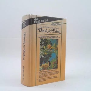May include: A hardcover book titled Back to Eden by Jethro Kloss, featuring a tan dust jacket with black text and a central rectangular illustration of a lush landscape. The cover includes the text New Revised Edition and The Authentic Kloss Family.