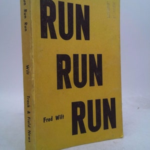 May include: A yellow book with the title "Run Run Run" in black text. The author is Fred Wilt. The book is a Track & Field News publication.