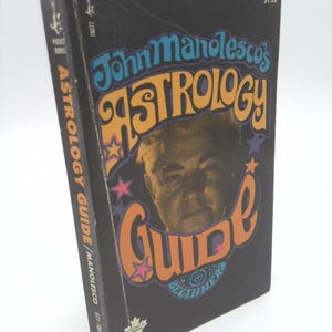 May include: A black and orange book titled "John Manolesco's Astrology Guide for Beginners" with a psychedelic design and a picture of a man on the cover.