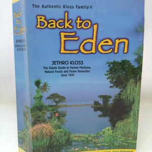 May include: A book titled "Back to Eden" with a blue cover and yellow accents. The cover features the title in large orange letters, the author's name, and a landscape illustration. The book is a guide to herbal medicine and natural foods.