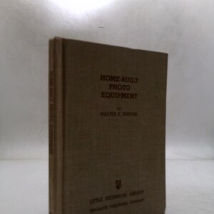 May include: A vintage book titled "Home-Built Photo Equipment" by Walter E. Burton. The book has a tan cover with black lettering. The book is part of the Little Technical Library by Ziff-Davis Publishing Company.