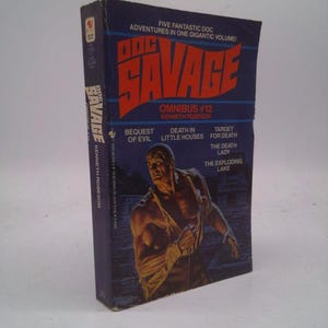 May include: A vintage paperback book titled "Doc Savage Omnibus #12" by Kenneth Robeson. The cover features a muscular man and the book's title in large, red letters. The book is dark blue with white text.