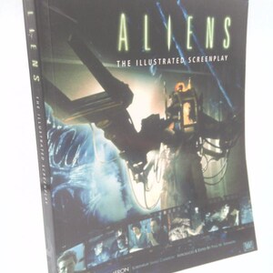 May include: A hardcover book titled "ALIENS The Illustrated Screenplay" with a dark cover featuring a science fiction scene. The book's spine reads "ALIENS The Illustrated Screenplay". The cover art includes images of characters and machinery.