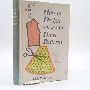 May include: A hardcover book titled How to Design Your Own Dress Patterns by Adele P. Margolis. The off-white cover features a graphic of a peach-colored bodice, a yellow skirt with a black floral pattern, and black scissors with small dots.