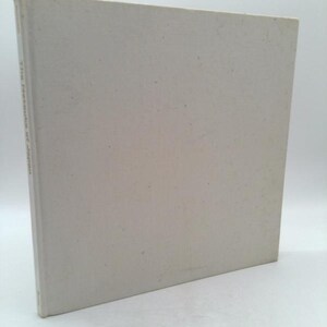 May include: A white book with the text "The Nature of Japan" printed on the spine.