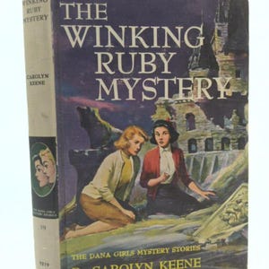May include: Vintage hardcover book titled "The Winking Ruby Mystery" by Carolyn Keene. The cover features two women in a mysterious setting, with the title in large white letters. The spine displays the author's name and the series title.