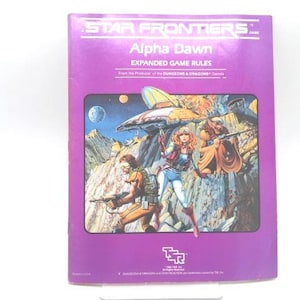 May include: A purple Star Frontiers Alpha Dawn Expanded Game Rules book. The cover features a colorful illustration of a futuristic scene with characters holding weapons, a spaceship, and a planet in the background.