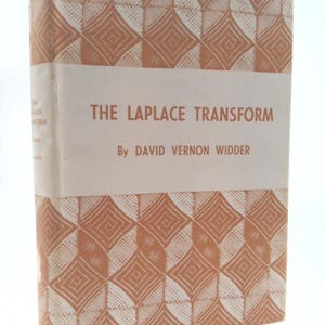 May include: A vintage book titled "The Laplace Transform" by David Vernon Widder. The book has a white spine and a cover with a repeating geometric pattern in shades of orange and white. The title and author's name are printed in a simple, sans-serif font.