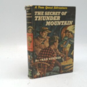 May include: A vintage hardcover book titled "The Secret of Thunder Mountain" by Fran Striker. The cover features an illustration of men in a cave. The book is part of "A Tom Quest Adventure" series.