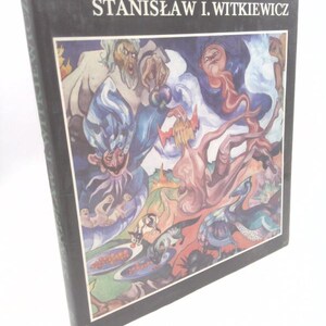 May include: A hardcover book with the title "STANISŁAW I. WITKIEWICZ" in white text on a black background. The cover features a colorful, surreal illustration with figures in shades of blue, red, and green. The book is angled slightly, showing its spine.