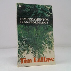 May include: A book titled "Temperamentos Transformados" by Tim LaHaye. The cover features a green and white image of trees reflected in water. The book is standing upright against a white background.