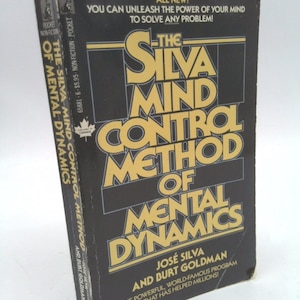 May include: A black and gold book titled "The Silva Mind Control Method of Mental Dynamics" by José Silva and Burt Goldman. The book cover features the title in large, bold letters and a smaller subtitle that reads "The Powerful, World-Famous Program That Has Helped Millions!"
