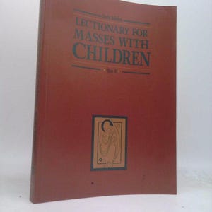 May include: A maroon book titled "Lectionary for Masses with Children" with text in dark teal. The book has a rectangular image of a person in a frame on the front cover. The book is a study edition.