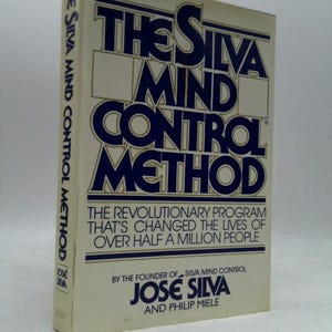 May include: A hardcover book titled "The Silva Mind Control Method." The cover is off-white with navy blue text. The title is in a bold, stylized font. The book's spine also features text. The book is a self-help guide.