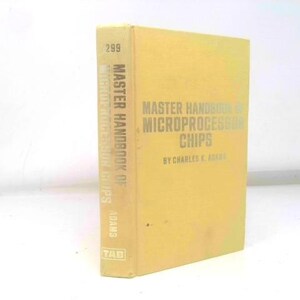 May include: A vintage book titled "Master Handbook of Microprocessor Chips" by Charles K. Adams. The book has a yellow cover with silver lettering and the number 299 on the top. The book is standing upright.