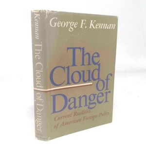 May include: A hardcover book titled "The Cloud of Danger" by George F. Kennan. The book has a green cover with blue lettering and the subtitle "Current Realities of American Foreign Policy."