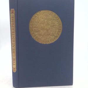 May include: A hardcover book titled "The Great Enterprise" with a dark blue cover. A gold-colored circular emblem is centered on the front. The spine features the title in gold lettering. The book is in good condition.