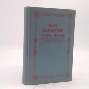 May include: A vintage cookbook titled "Gay Nineties Cook Book" with a teal cover and red decorative border. The book's title is in large, bold letters, and the author's name is also visible.