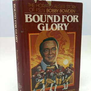 May include: A hardcover book titled "BOUND FOR GLORY" by Bobby Bowden. The cover features a portrait of Bobby Bowden and football players in maroon and gold uniforms. The book's spine reads "BOUND FOR GLORY" and "Bowden/Bynum".