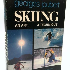 May include: A vintage book titled "SKIING" by Georges Joubert. The cover is black with white text and features images of skiers in action. The book's subtitle reads "AN ART... A TECHNIQUE."