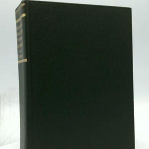 May include: A hardcover book with a dark green cover. The spine has gold lettering and a gold band. The book is standing upright against a white background. The title on the spine is partially visible.