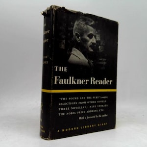 May include: A hardcover book titled "The Faulkner Reader" with a black cover and a portrait of a man. The title is in white, with a yellow horizontal stripe. The book includes selections from other novels, novellas, and stories.