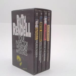 May include: A boxed set of four Inspector Wexford mysteries by Ruth Rendell. The dark gray box features the author's name and the series title in white. The spines of the books are visible, each with a title and author's name.