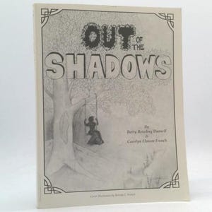 May include: A book titled "OUT OF THE SHADOWS" with a black and white illustration of a person on a swing under a tree. The cover has decorative corner designs and author names.